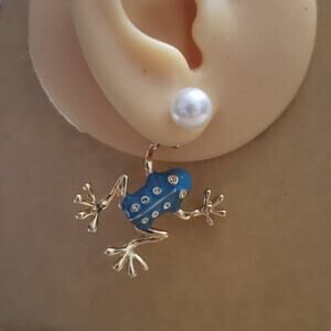 Adorable blue enamel & gold tone frog earrings hanging from synthetic pearl